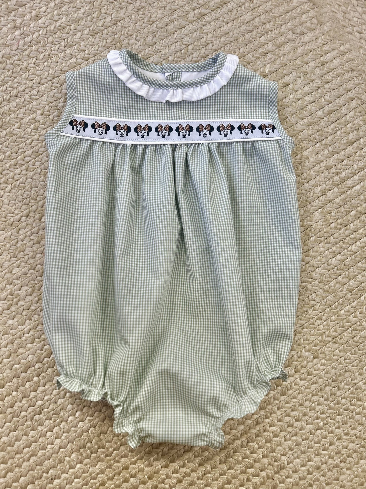 Sleeveless Harper Bubble in sage gingham with white ruffle neck, Minnie ribbon and white piping, flat lay