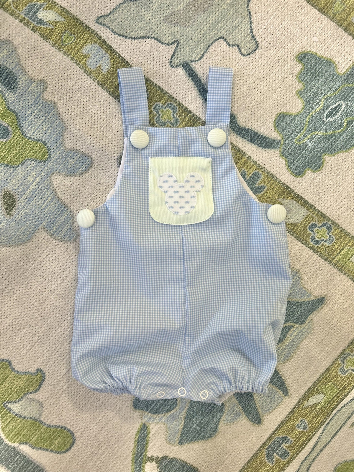 Hudson Romper in blue gingham with green pocket and blue Mickey appliqué, covered buttons